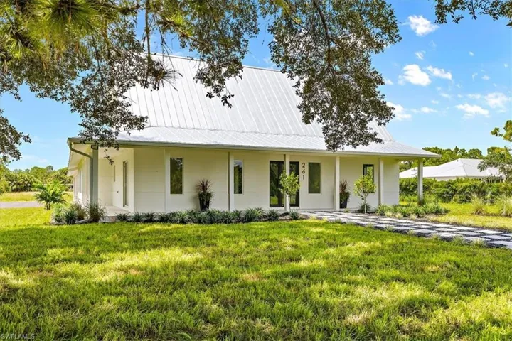 Country-style home with a front lawn
