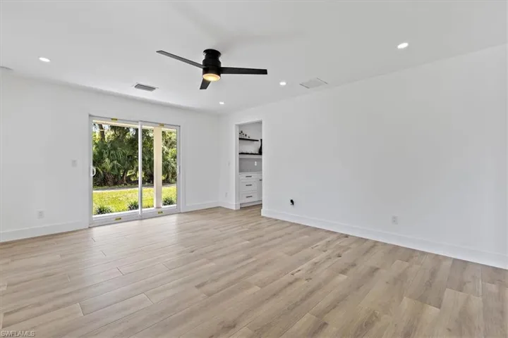 Empty room with light wood-type flooring and ceiling fan