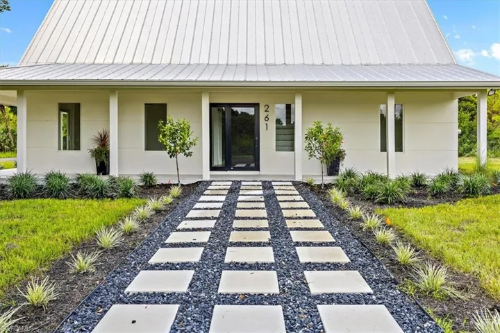View of exterior entry with covered porch