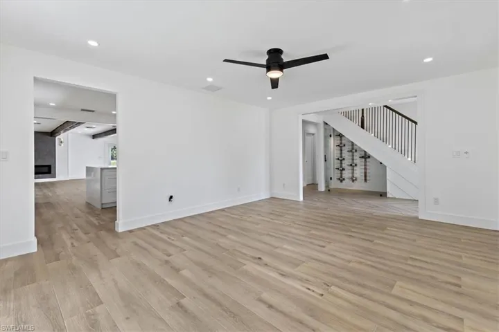 Unfurnished living room with ceiling fan and light hardwood / wood-style floors