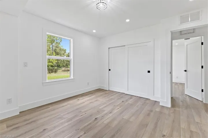 Unfurnished bedroom with a closet and light hardwood / wood-style flooring
