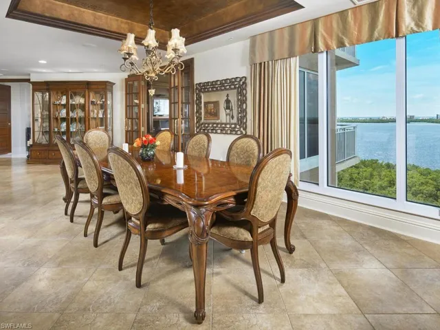 Formal dining area, open to the living and kitchen with a sunset view - spacious and charming.