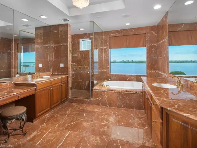 There is plenty of room for TWO in this grand primary bathroom. Walk in shower, soaking tub, two separate sink/counter areas with primary closet around the corner.