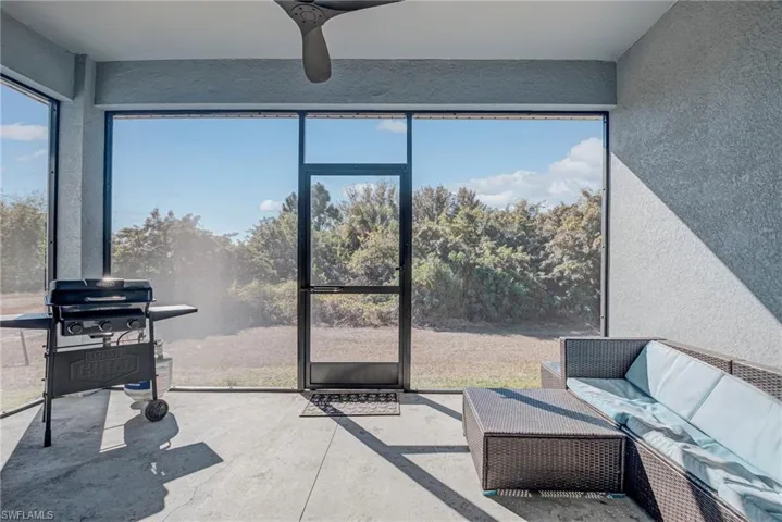 Sunroom featuring an outdoor hangout area and a ceiling fan
