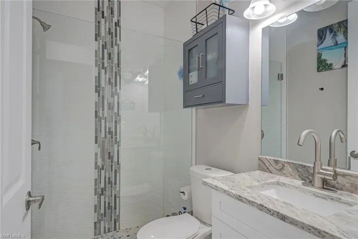 Full bathroom featuring vanity and a stall shower