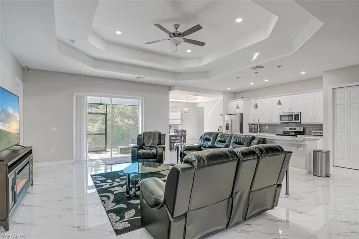 Living room featuring recessed lighting and a ceiling fan