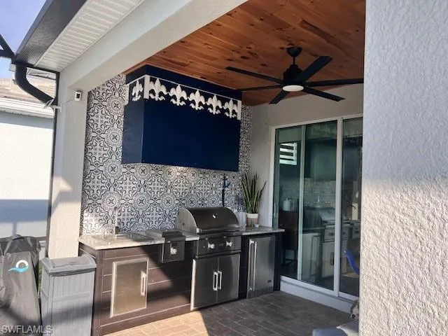 View of patio / terrace with an outdoor kitchen and a ceiling fan