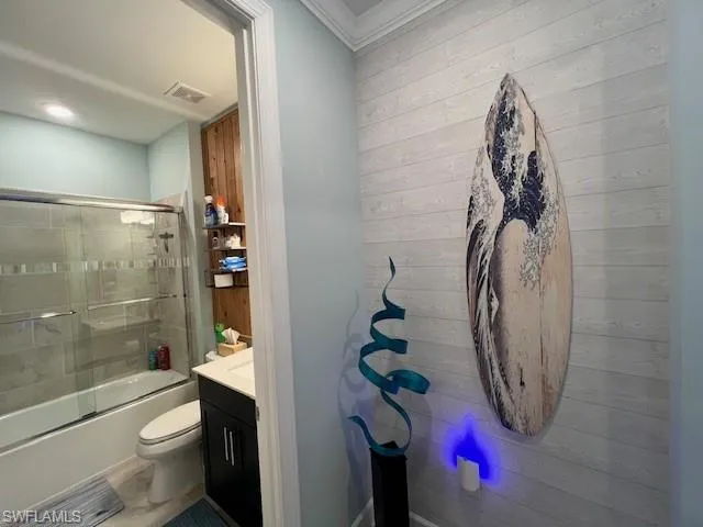 Full bathroom featuring vanity and shower / bath combination with glass door