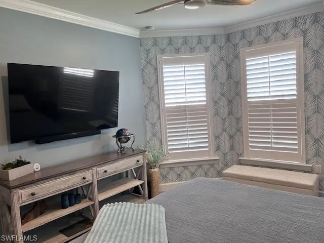 Bedroom featuring crown molding and ceiling fan
