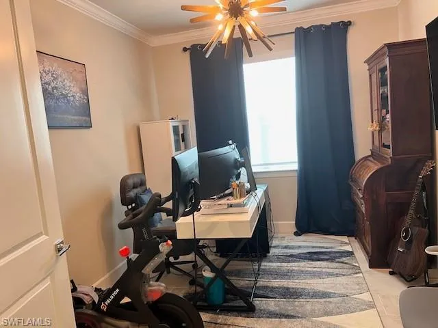 Office with ornamental molding and baseboards