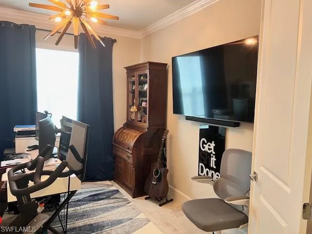Office space with ornamental molding and baseboards