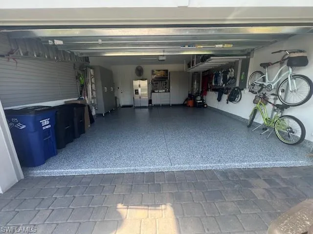 Garage featuring stainless steel fridge