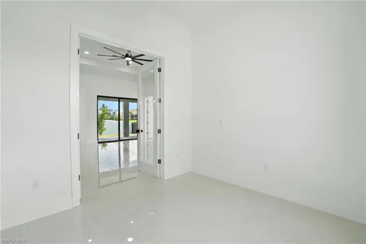 Empty room featuring light tile patterned floors, a ceiling fan, and recessed lighting
