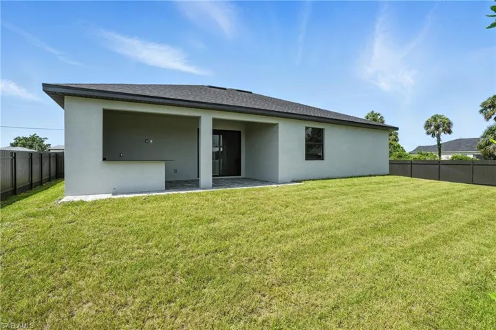 Rear view of house featuring a patio and stucco siding