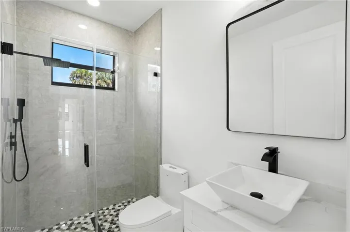 Full bathroom with a shower stall, vanity, and recessed lighting