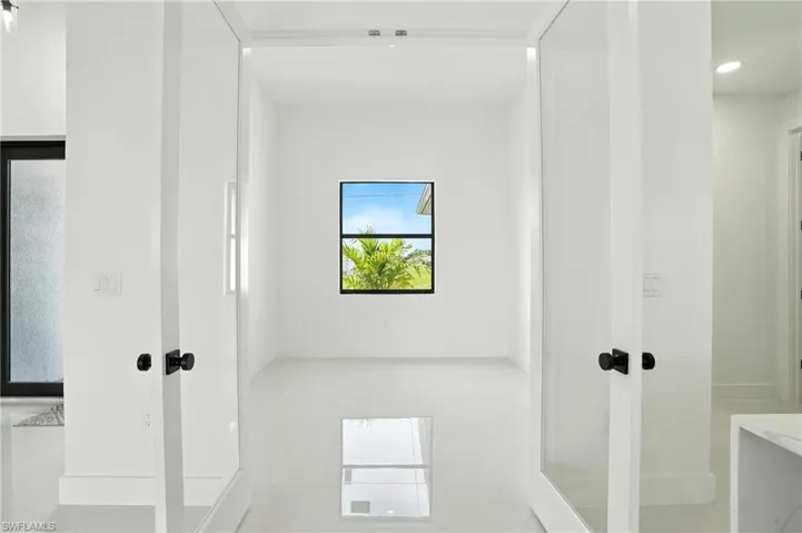 Hallway with tile patterned flooring