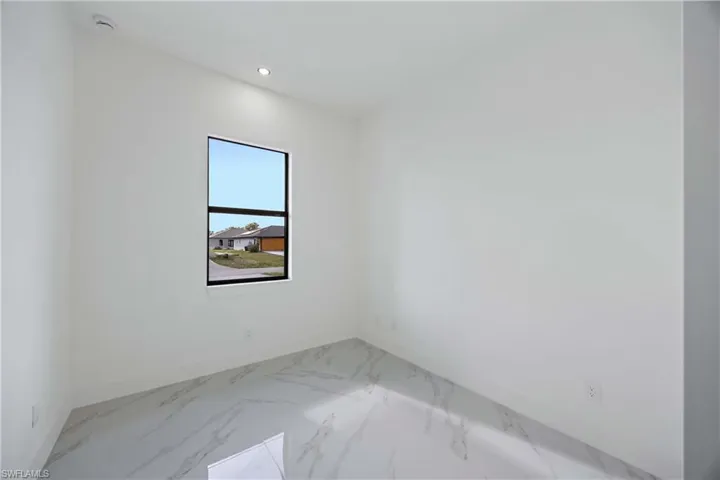 Unfurnished room with recessed lighting and light marble finish flooring