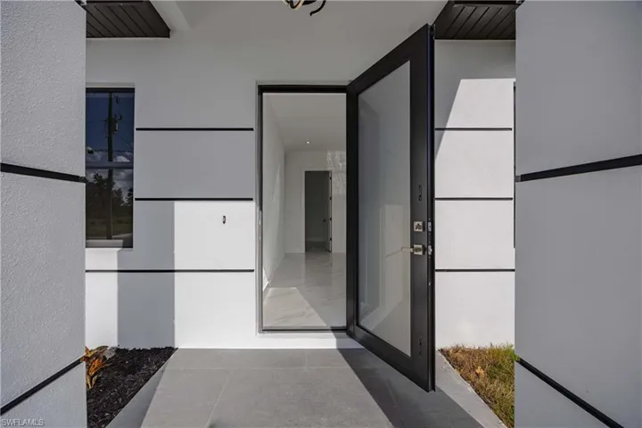 Entrance to property with stucco siding