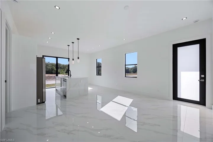 Unfurnished room with recessed lighting and light marble finish flooring