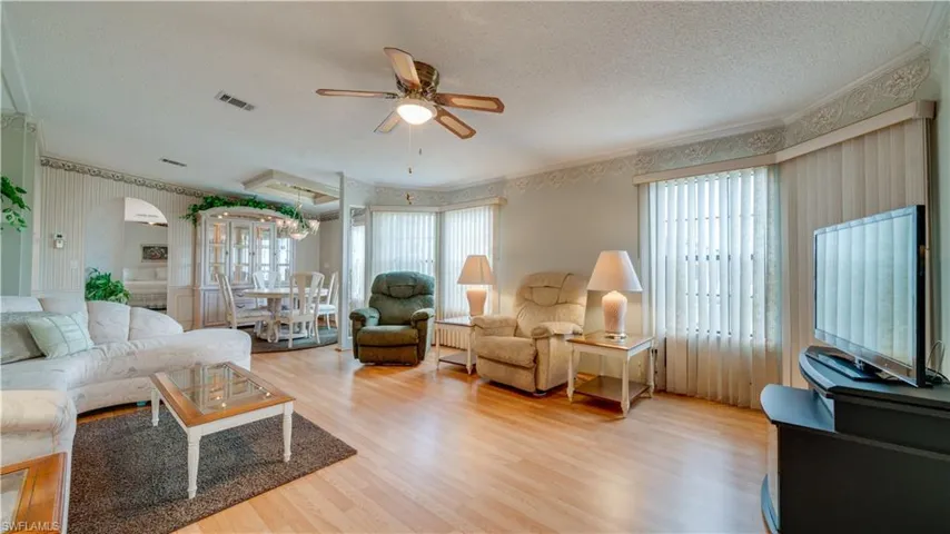 This home showcases an extra large living room. Windows, windows, everywhere!
