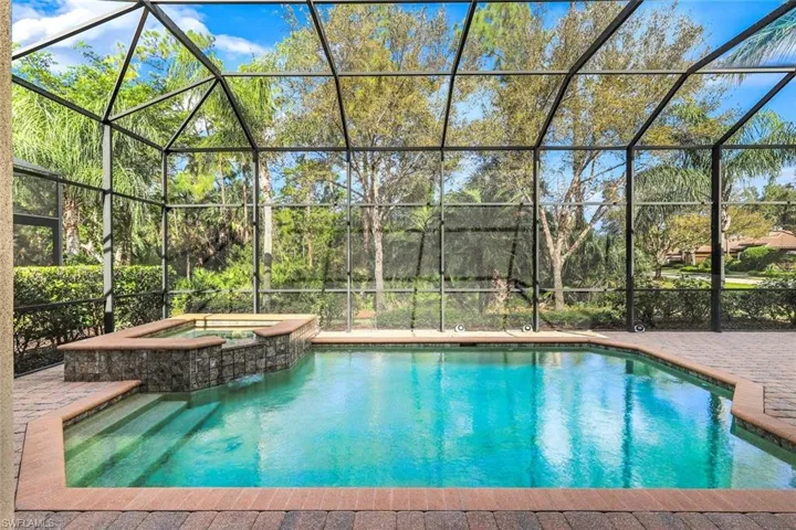 Combined pool / hot tub featuring a sunroom and a lanai