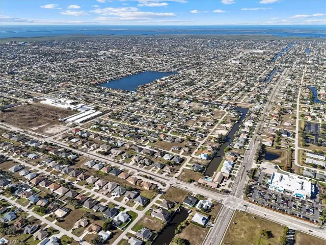 View of property location with a nearby body of water and nearby suburban area