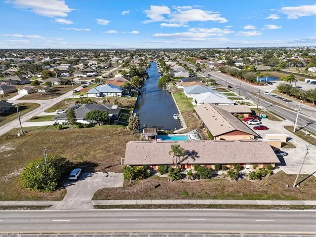 Aerial perspective of suburban area with a nearby body of water