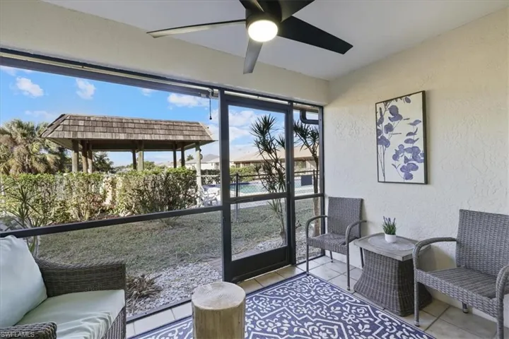Sunroom / solarium with a ceiling fan and outdoor lounge area