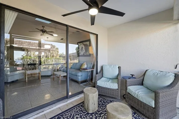 Sunroom with an outdoor living space and a ceiling fan