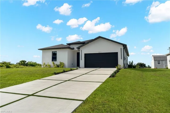 Contemporary stucco exterior with a dark shingle roof and a matching dark garage door