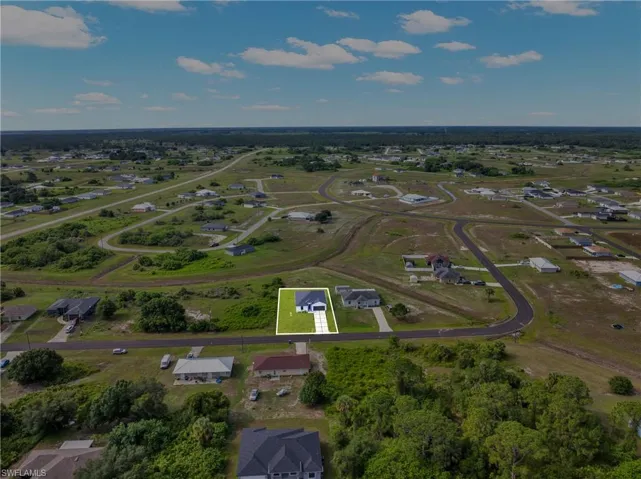 Aerial perspective showcasing the property within a developing residential area