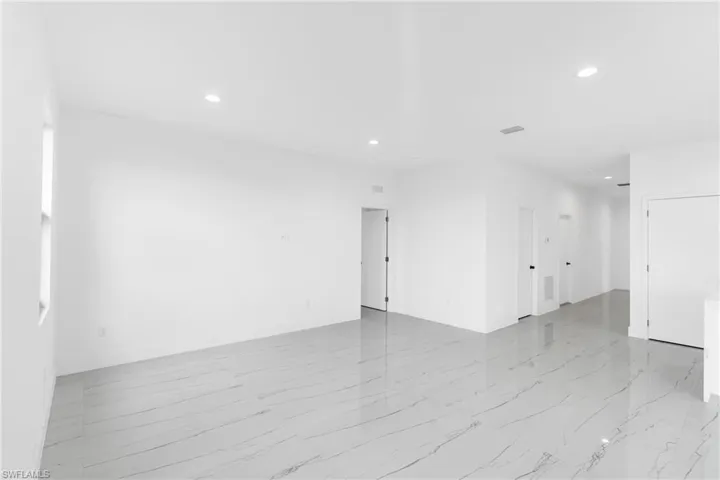 Bright interior space featuring large format marble-look tile flooring