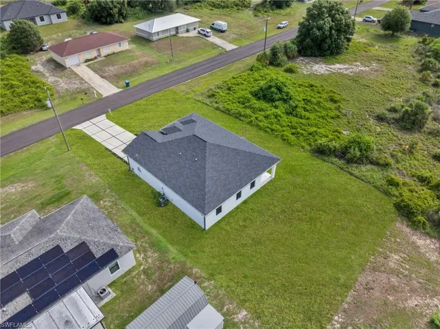 Newly constructed home featuring a dark shingle roof and white siding