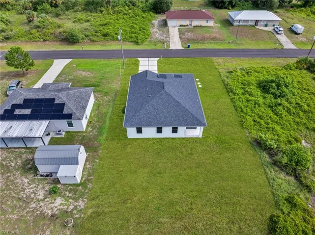Single-story residence featuring a dark shingle roof and white exterior siding