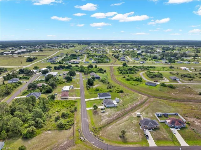 Aerial perspective showcasing a residential area with varied housing styles and expansive green spaces
