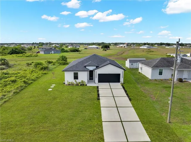 Contemporary single-story residence with a dark shingle roof and a two-car garage