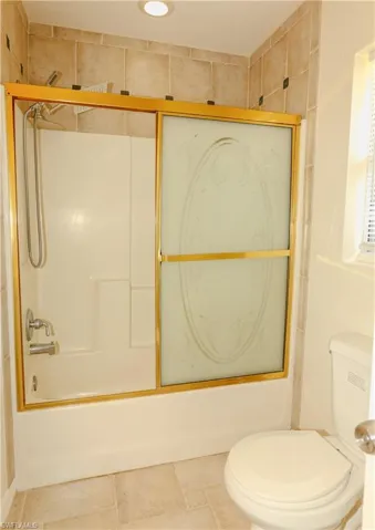 Full bathroom featuring combined bath / shower with glass door and recessed lighting