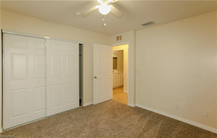 Unfurnished bedroom with a closet, light carpet, and ceiling fan