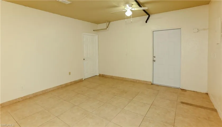 Bonus room featuring light tile patterned flooring and a ceiling fan