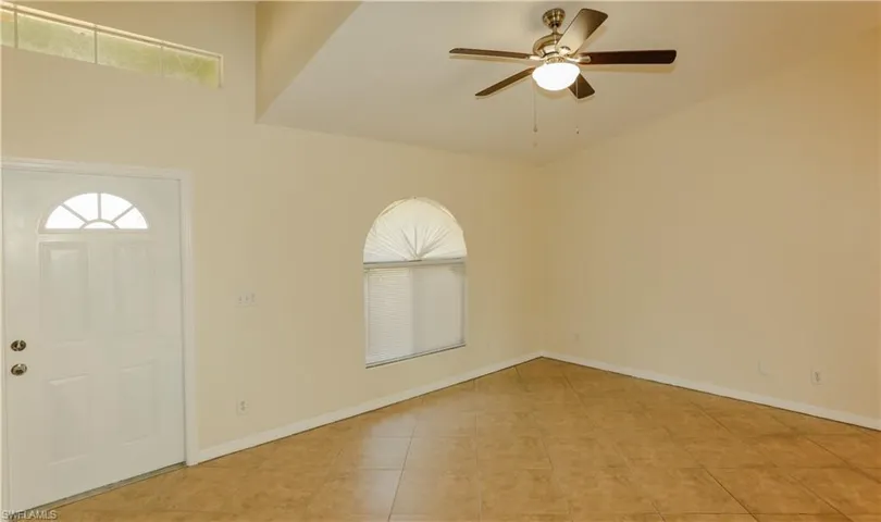 Foyer entrance featuring a ceiling fan and light tile patterned floors