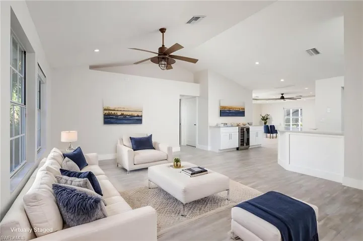 Living area featuring vaulted ceilings, recessed lighting, luxury vinyl flooring and new baseboards and trim throughout.