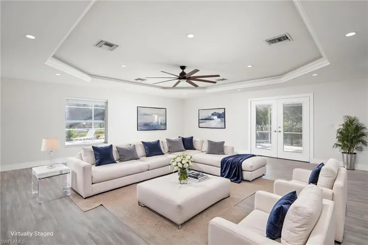 The property's living area features recessed lighting, a ceiling fan, and crown molding