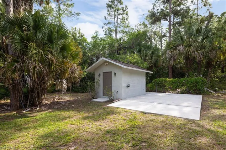 The property features an outbuilding with electric and water situated on a concrete slab. Perfect for hobbies, projects or extra storage.