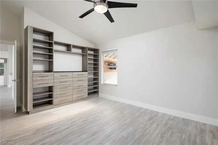 The primary bedroom features built-in shelving and drawers.