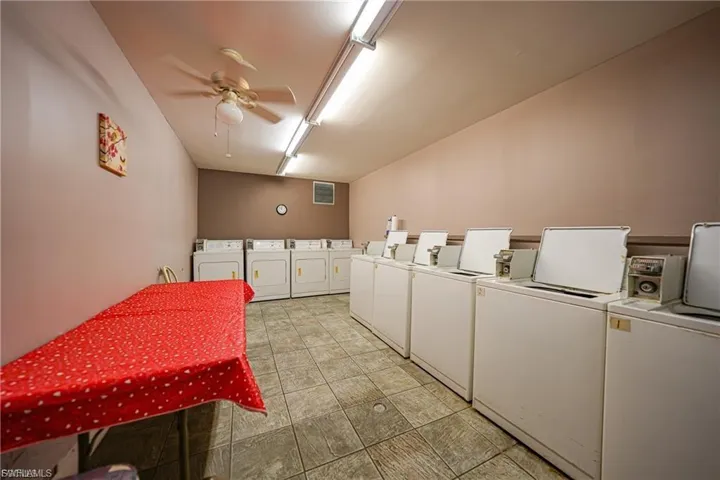 Shared laundry featuring washer and dryer and ceiling fan