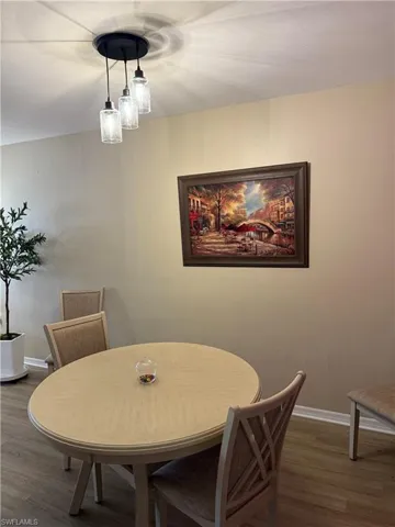 Dining space with wood finished floors and baseboards