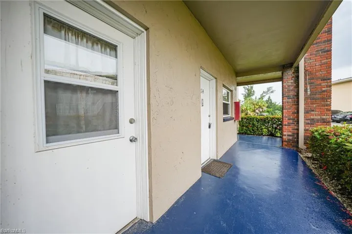 View of exterior entry featuring stucco siding