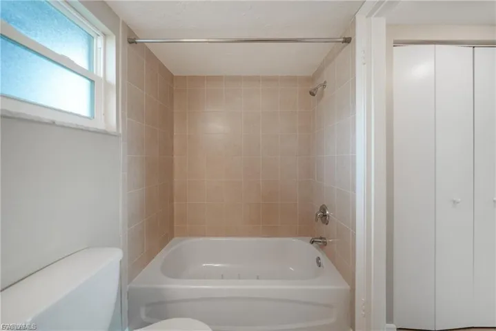 Bathroom featuring shower / bath combination and toilet