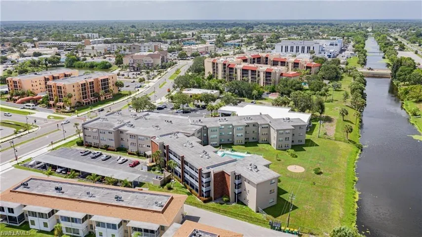 Aerial view of a large body of water and apartment complex / building