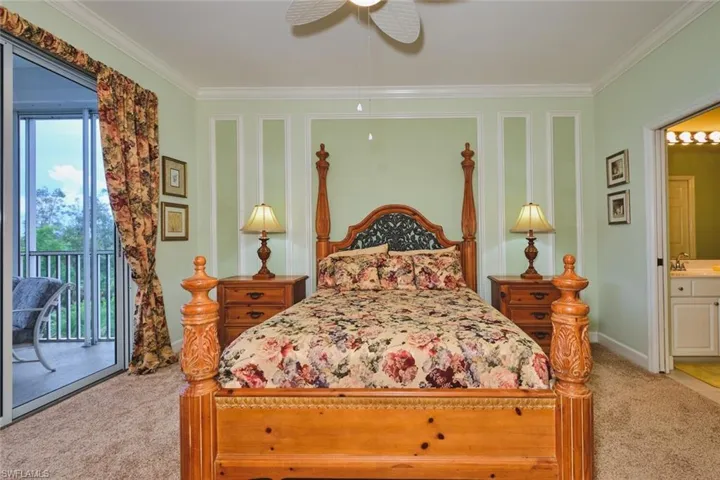 Bedroom featuring crown molding, access to exterior, light colored carpet, connected bathroom, and ceiling fan